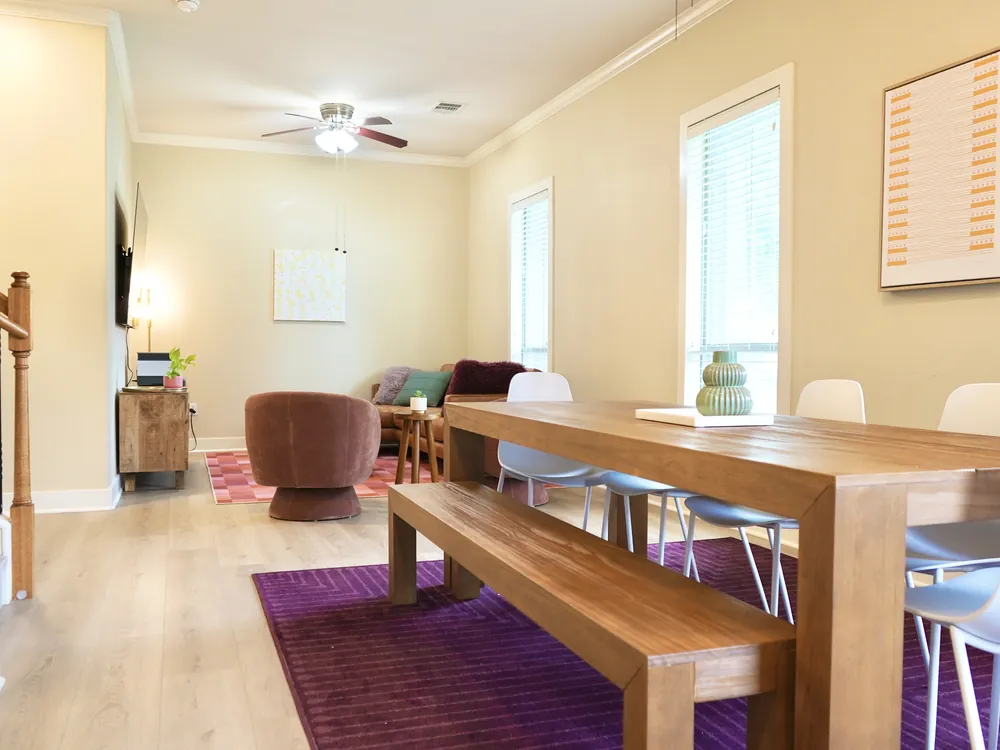 A long wooden dining table with bench seating in Empowered Treatment's transitional housing