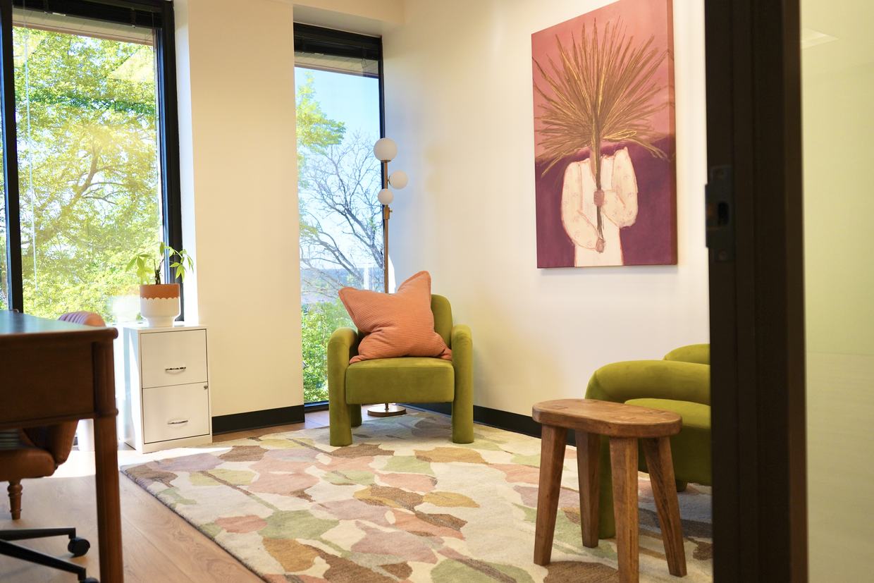 A therapy room at Empowered Treatment, with a wide window looking out over the Northwest Austin treeline