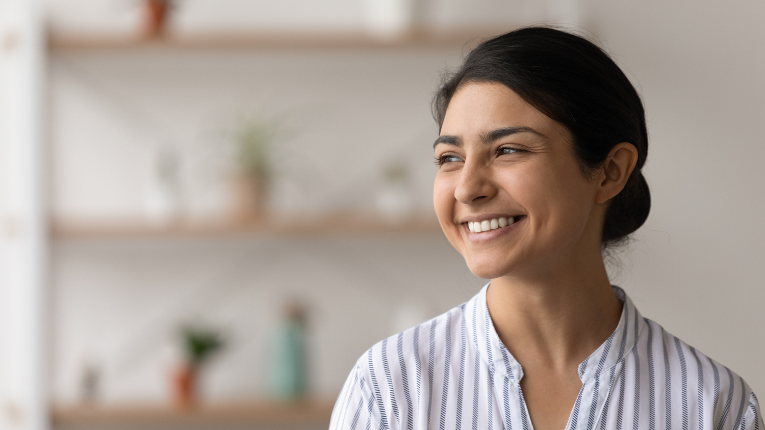 A woman smiling indoors.