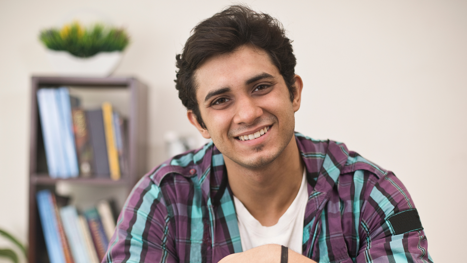 A portrait of a young man indoors.