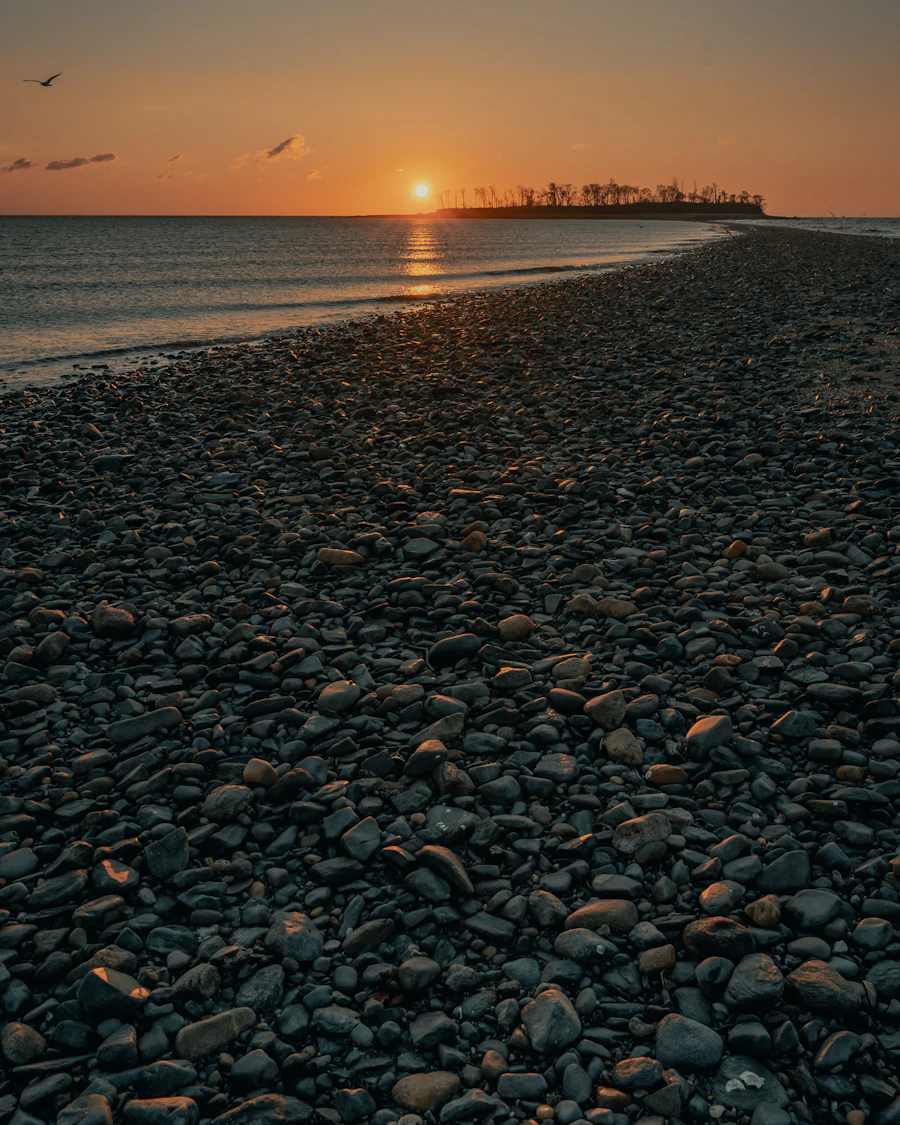 Sunrise over a stony shoreline at Walnut Beach in Milford, Connecticut
