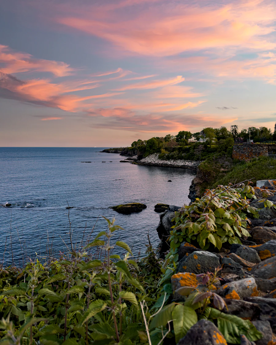 The Cliff Walk shoreline at dusk in Newport, Rhode Island