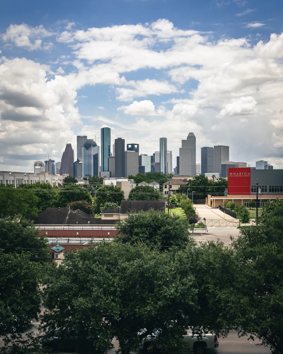 The downtown Houston skyline above green trees